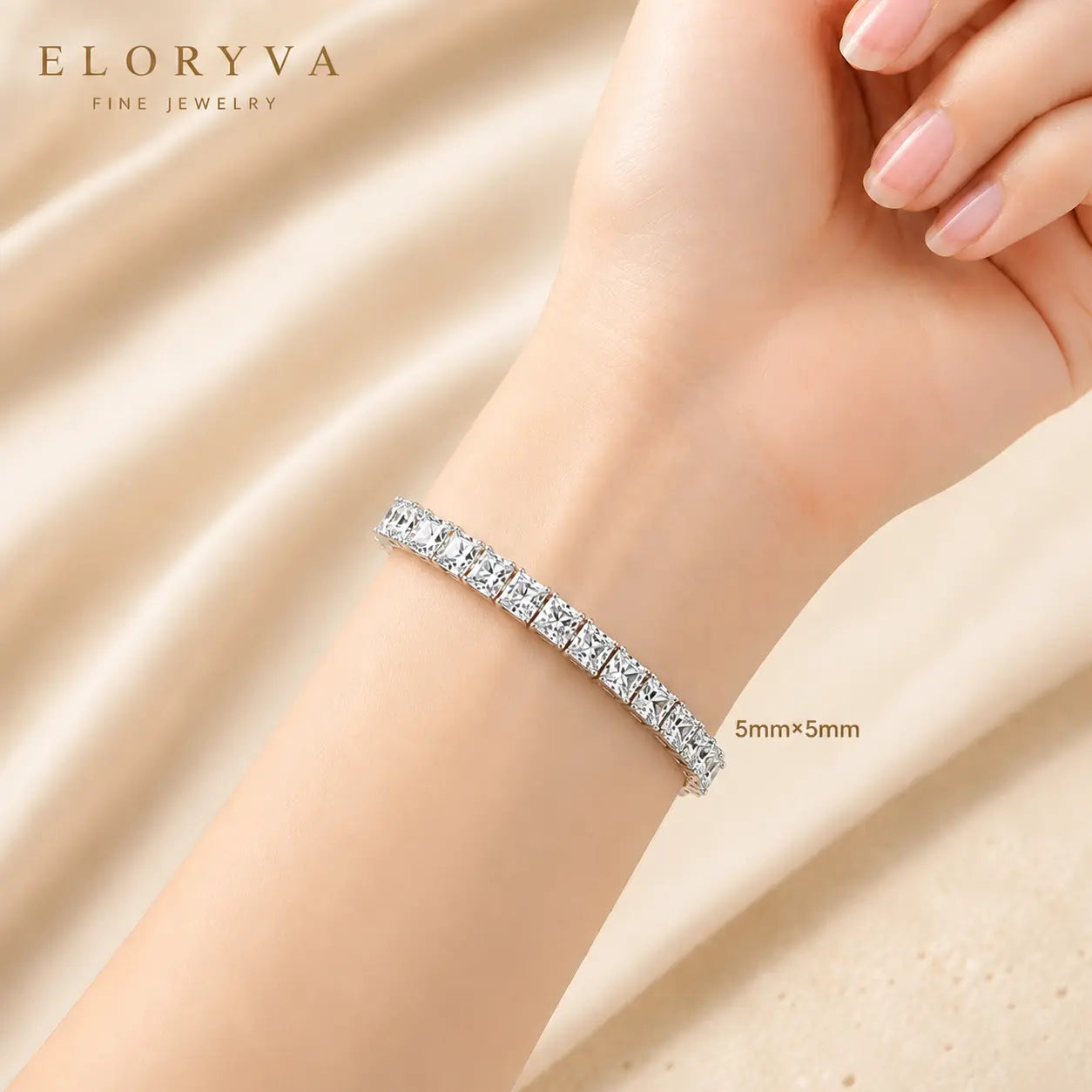 Woman wearing a bold 5mm round moissanite tennis bracelet with brilliant stones on the wrist.