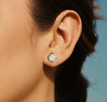 Round moissanite stud earring worn on ear, showing elegant everyday size and sparkle.