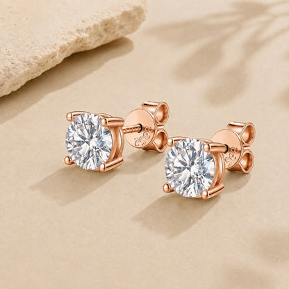 Rose gold moissanite stud earrings in 925 sterling silver displayed on a soft beige luxury background.