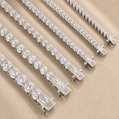 Close-up of Cirelle™ round moissanite tennis bracelets showing brilliant stones and secure silver-tone clasps.
