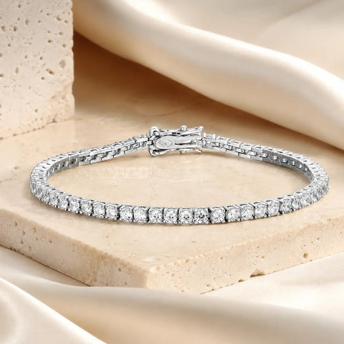 Cirelle™ round moissanite tennis bracelet for women displayed on a luxury beige stone surface.