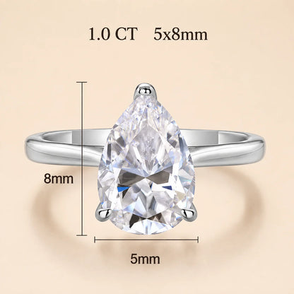 1 carat pear-cut moissanite engagement ring with a 5 x 8 mm center stone in a polished silver setting.