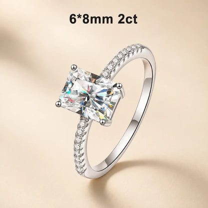 2 carat radiant-cut moissanite engagement ring with a 6 x 8 mm center stone and delicate pavé band.