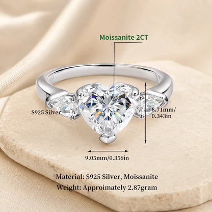 Three-carat heart-cut moissanite ring in S925 sterling silver with brilliant side stones and size details.