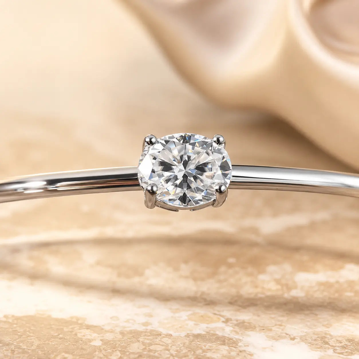 Close-up of a 2CT oval-cut moissanite bangle bracelet featuring a brilliant solitaire stone in a four-prong setting.