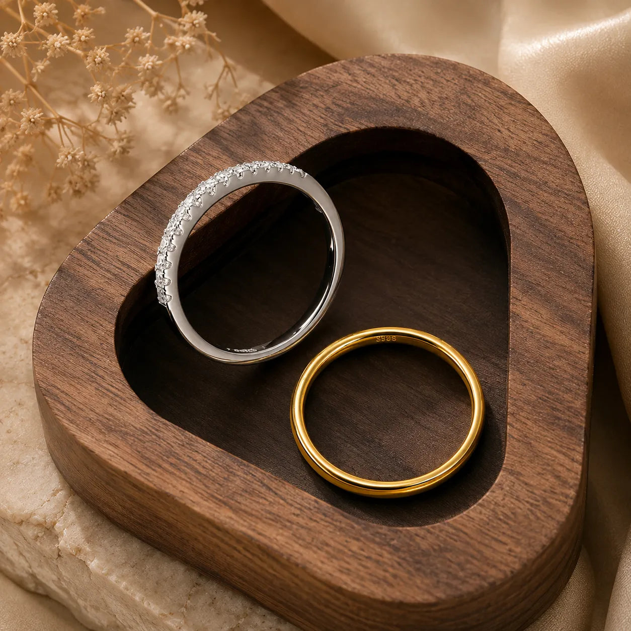Gold and silver Bexley™ Moissanite Stacking Rings for Women styled together in a luxury wooden tray.