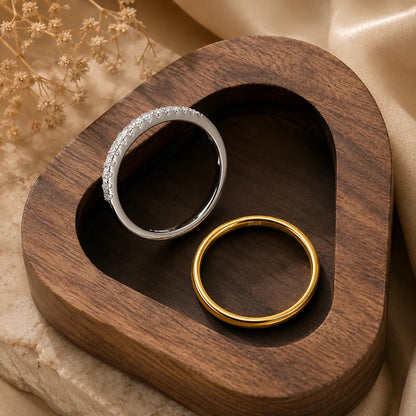 Gold and silver Bexley™ Moissanite Stacking Rings for Women styled together in a luxury wooden tray.