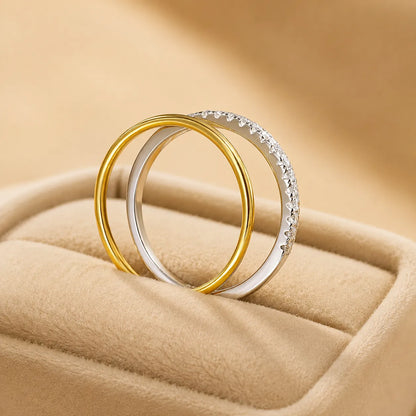 Bexley™ Moissanite Stacking Rings for Women in gold and silver finishes displayed upright in a beige jewelry box.