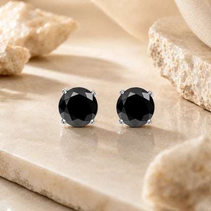 Eloryva black round-cut gemstone stud earrings featuring a polished silver-tone four-prong setting.