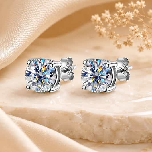 Eloryva clear round brilliant-cut stud earrings in a timeless silver-tone four-prong setting.
