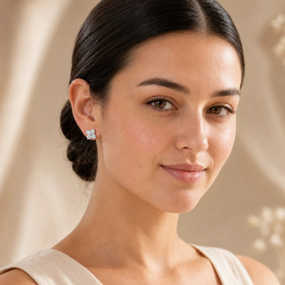 Woman wearing Elaris™ Four-Petal Moissanite Stud Earrings for an elegant everyday look.