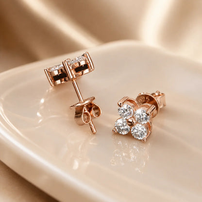 Front and back views of Elaris™ rose gold four-petal moissanite stud earrings showing the posts and butterfly backs.