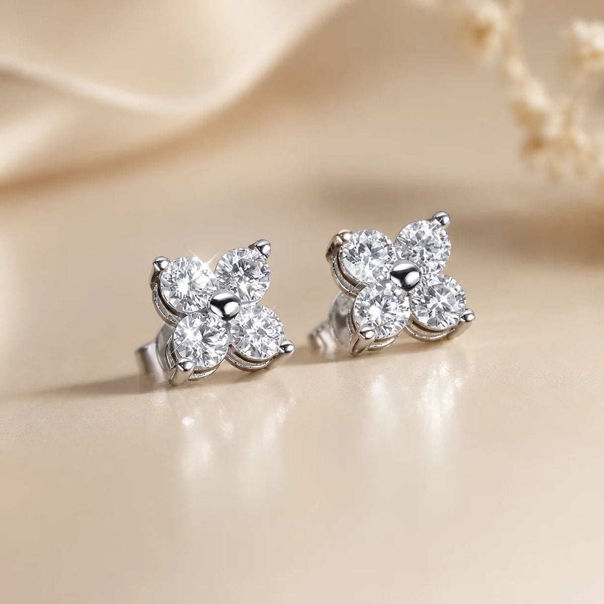 Side view of Elaris™ silver four-petal moissanite stud earrings showing the raised prong settings and secure posts.