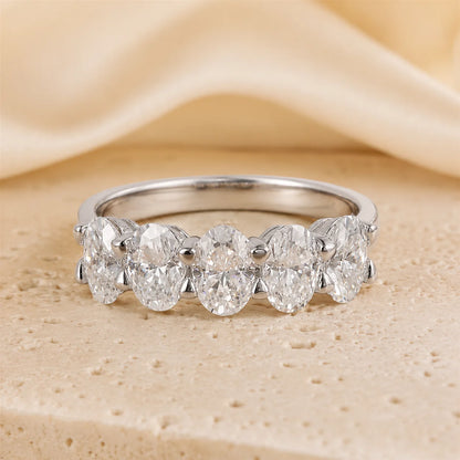 Front view of a five-stone oval-cut moissanite ring featuring brilliant graduated stones in a polished sterling silver setting.