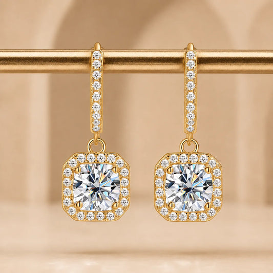 Marielle™ gold halo moissanite drop earrings featuring brilliant center stones and delicate pavé detailing.