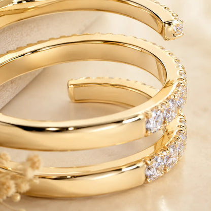 Close-up side view of a gold three-row moissanite wrap ring showing its polished open-band design and stone settings.