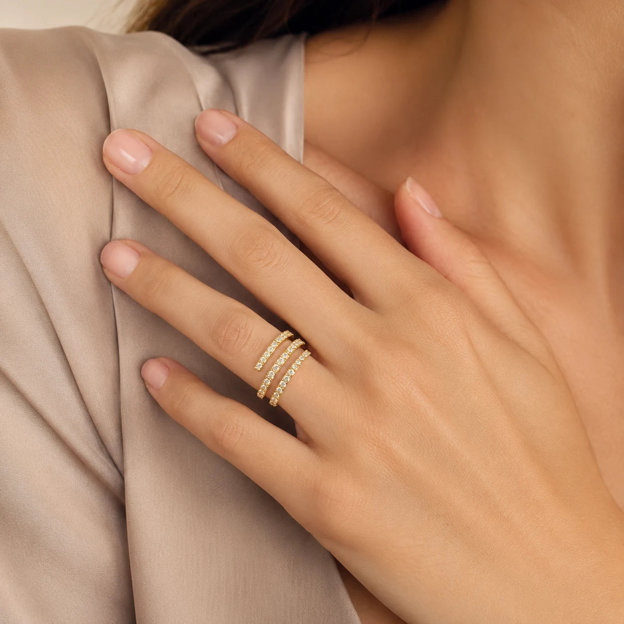 Close-up of a woman wearing a gold three-row moissanite wrap ring for an elegant everyday look.