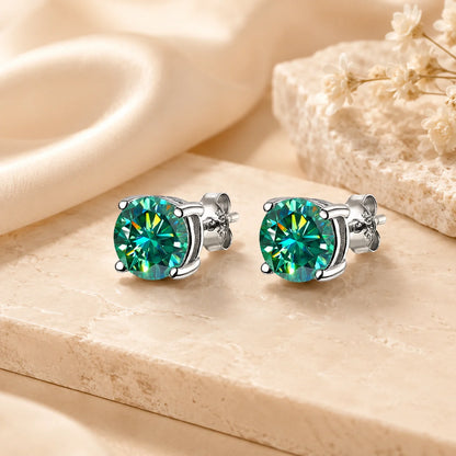 Eloryva green-blue round-cut gemstone stud earrings with vibrant color and brilliant light reflection.