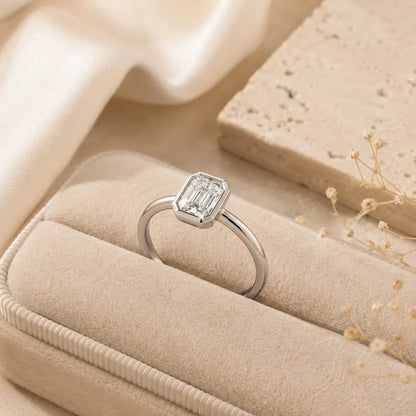 Hadley™ 2CT Emerald-Cut Moissanite Engagement Ring displayed inside a beige velvet jewelry box with soft luxury styling.