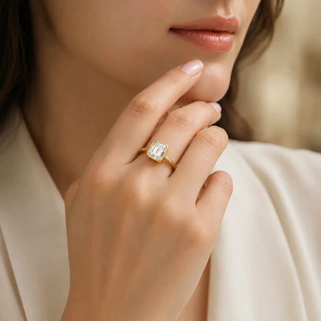 Woman wearing the Hadley™ 2CT Emerald-Cut Moissanite Engagement Ring in a gold-tone finish for an elegant luxury look.