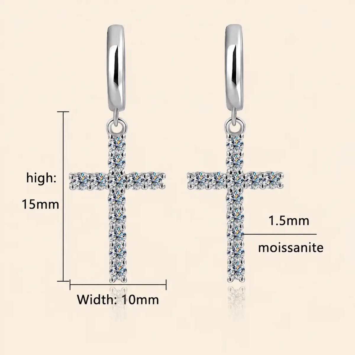 Dainty silver-tone cross drop hoop earrings with sparkling moissanite stones on a beige surface.