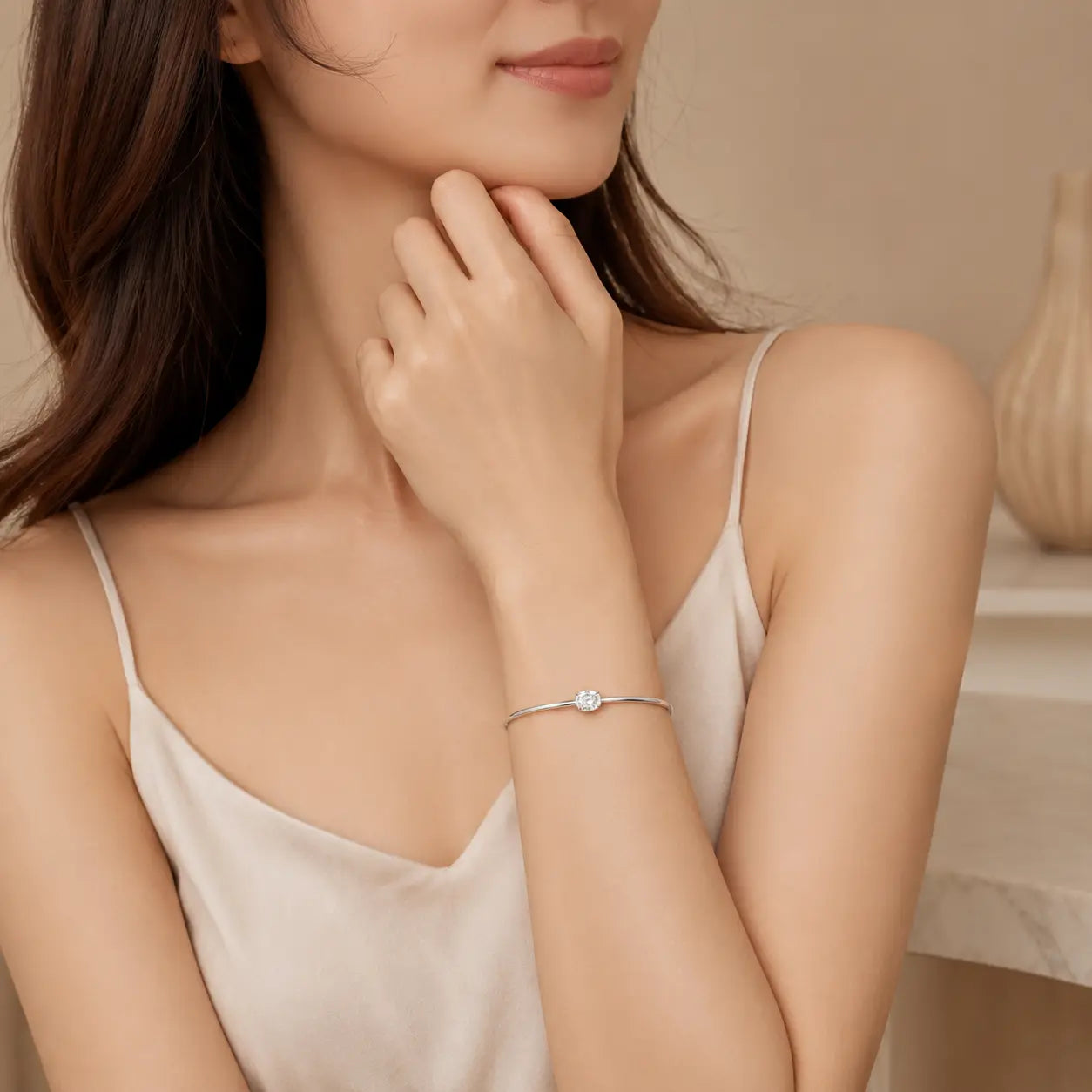 Woman wearing a silver oval-cut moissanite bangle bracelet for an elegant and refined everyday look.