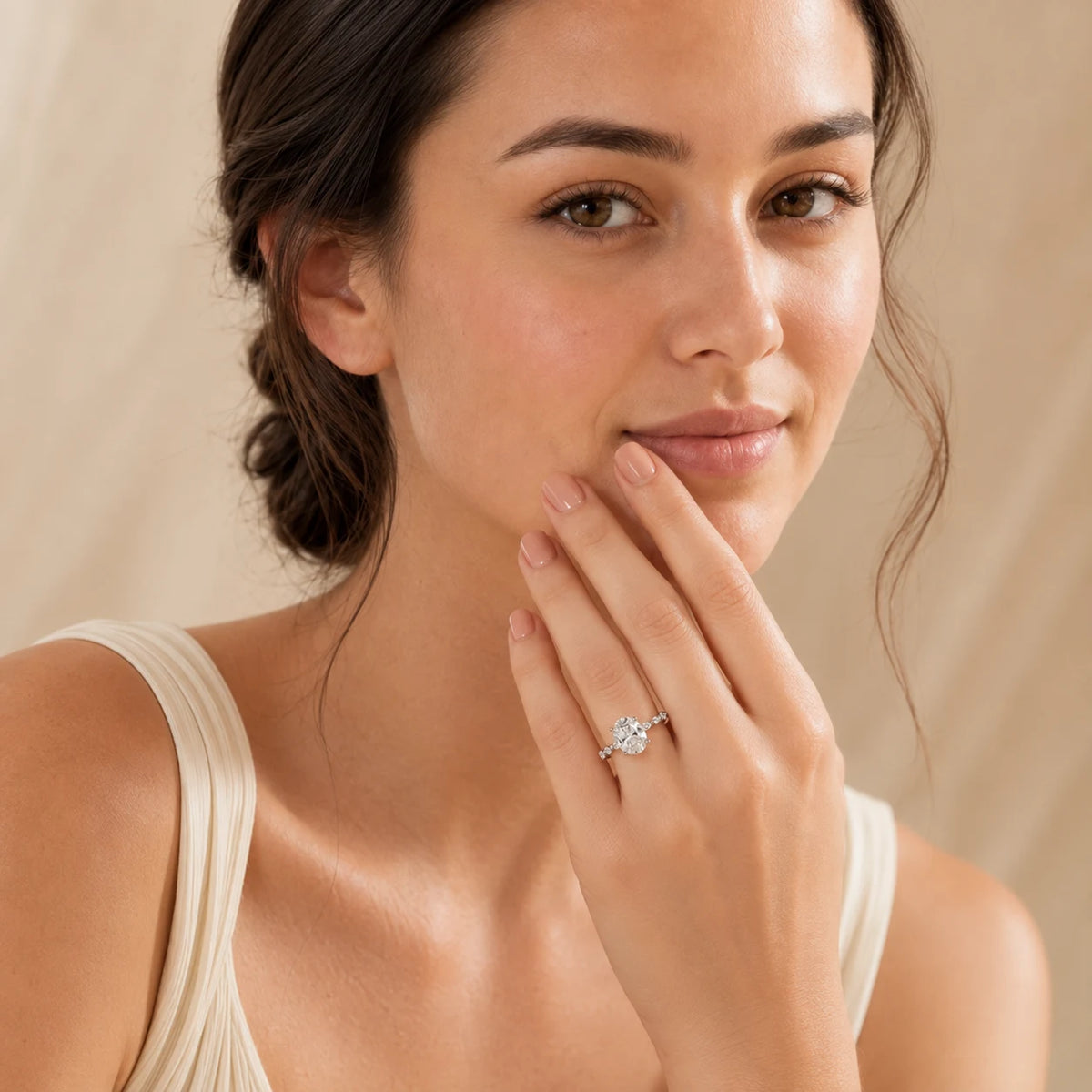 Woman showcasing an elegant oval-cut moissanite ring designed for engagements, anniversaries and special occasions.