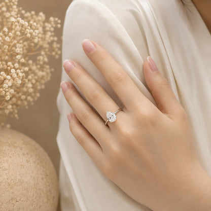 Woman wearing a pear-cut moissanite engagement ring for an elegant and refined look.