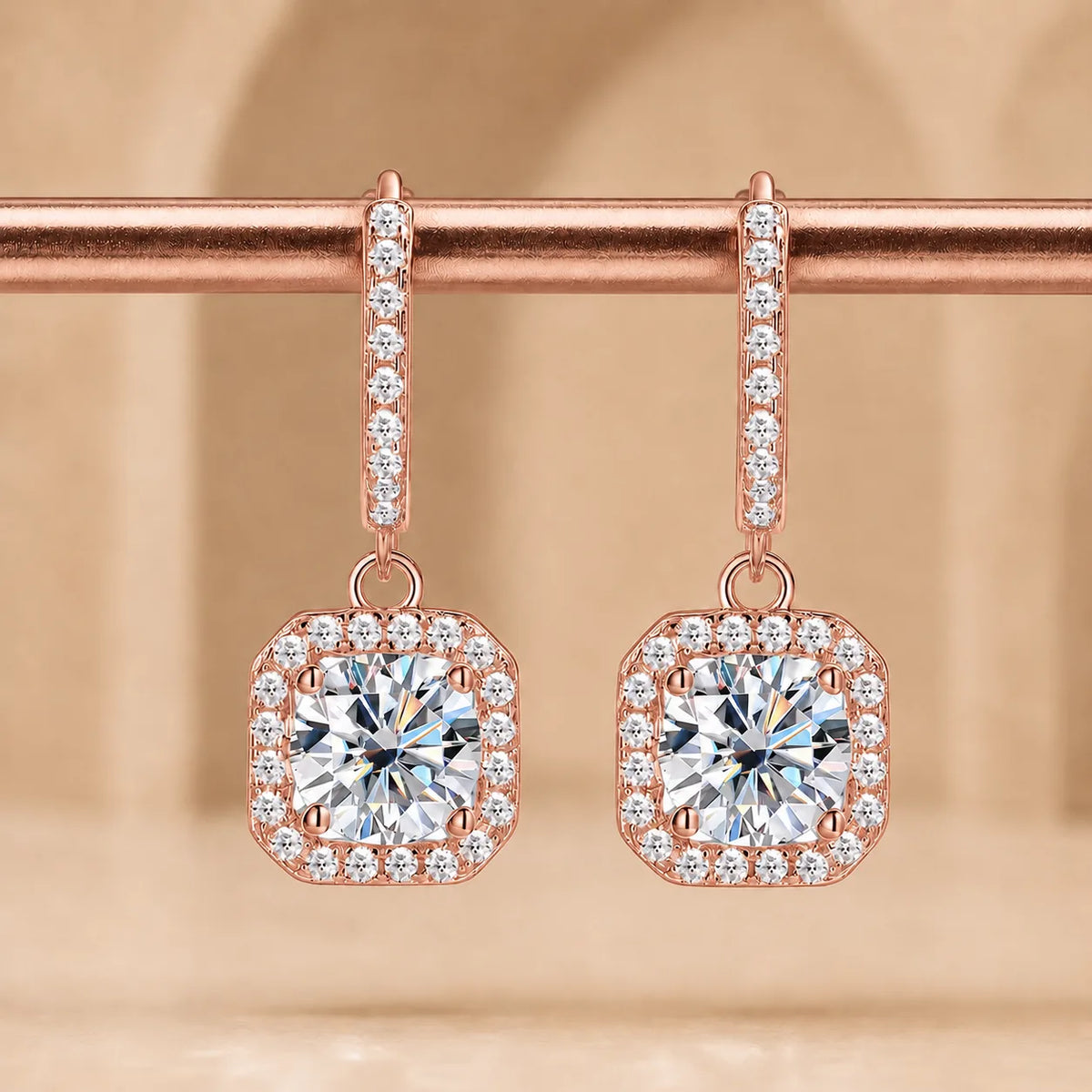 Marielle™ rose gold halo moissanite drop earrings with sparkling round center stones and pavé-set borders.