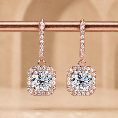 Marielle™ rose gold halo moissanite drop earrings with sparkling round center stones and pavé-set borders.