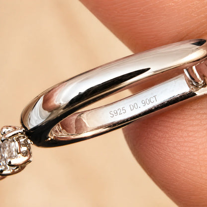 Close-up of the S925 hallmark and polished hinged clasp on a sterling silver three-stone drop earring.