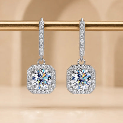 Marielle™ silver moissanite drop earrings with brilliant round stones surrounded by sparkling cushion halos.