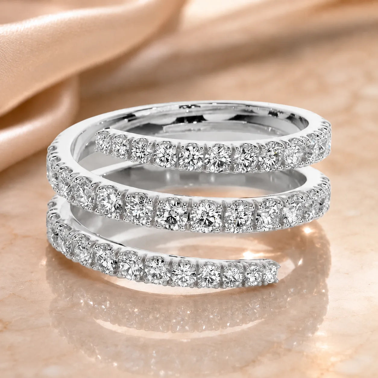 Silver three-row moissanite wrap ring featuring brilliant round stones in a modern open-band silhouette.