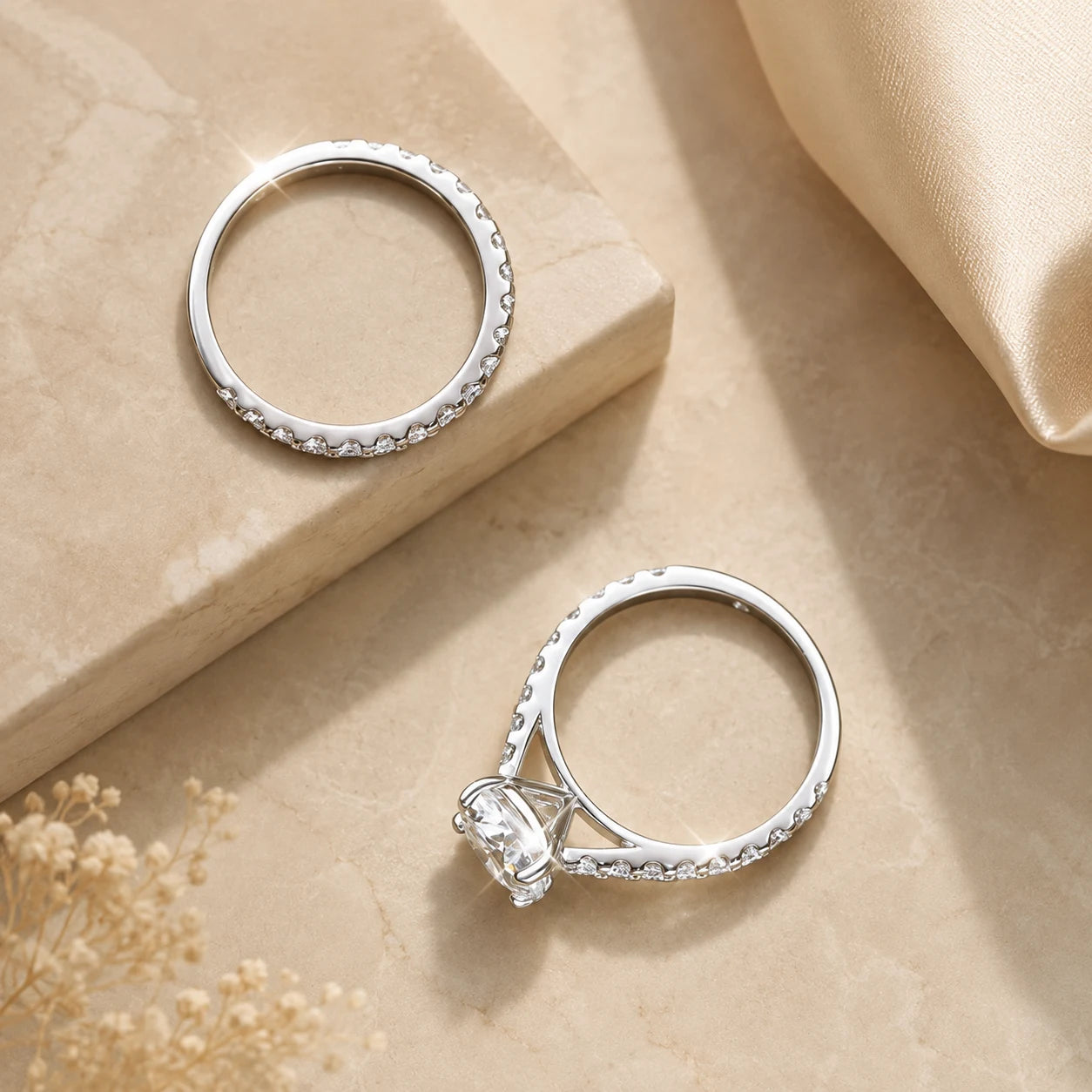 Sutton™ round moissanite solitaire engagement ring displayed beside its matching pavé wedding band.