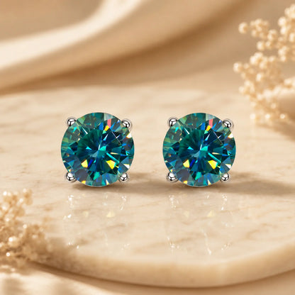 Eloryva teal round-cut gemstone stud earrings with vivid blue-green sparkle and a classic prong setting.