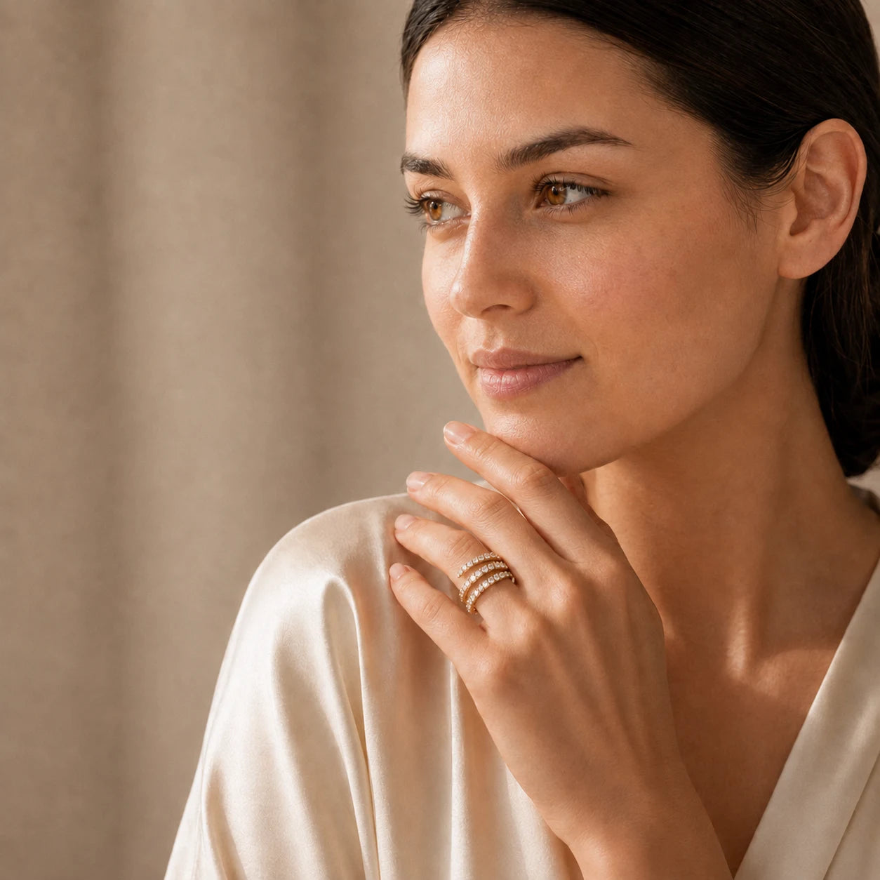 Woman wearing an elegant three-row moissanite wrap ring with a polished gold finish.