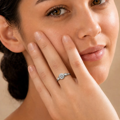 Woman wearing a silver three-stone moissanite ring with a brilliant round center stone for an elegant everyday look.
