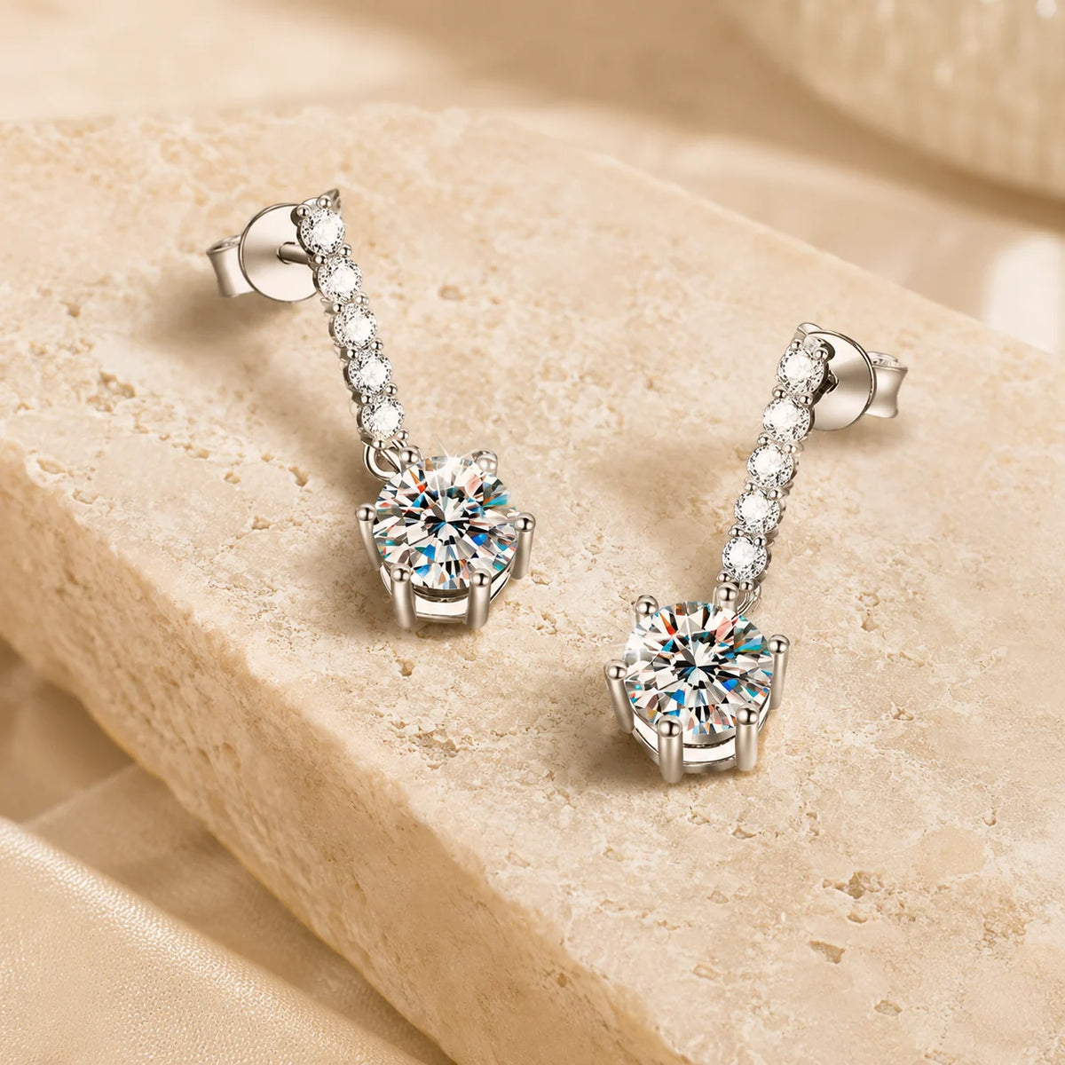 Angled view of Valenne™ 2CT Moissanite Drop Stud Earrings featuring a slim stone-set bar and brilliant round drop stones.