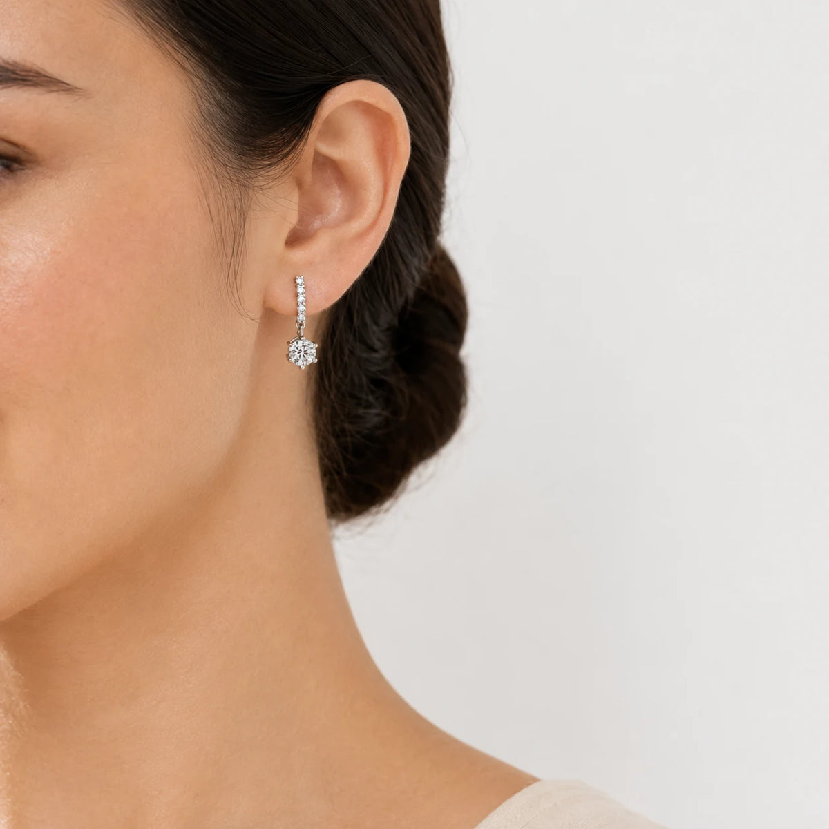 Woman wearing Valenne™ 2CT Moissanite Drop Stud Earrings for an elegant and refined look.
