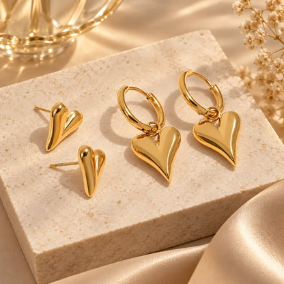 Gold heart earrings set featuring heart stud earrings and dangling heart hoops