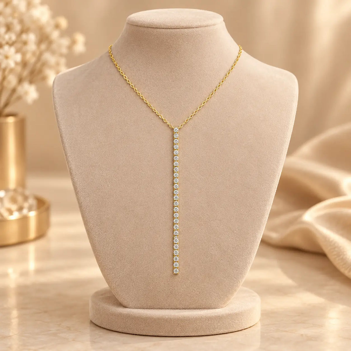 Gold tone moissanite vertical bar necklace displayed on a soft beige jewelry bust