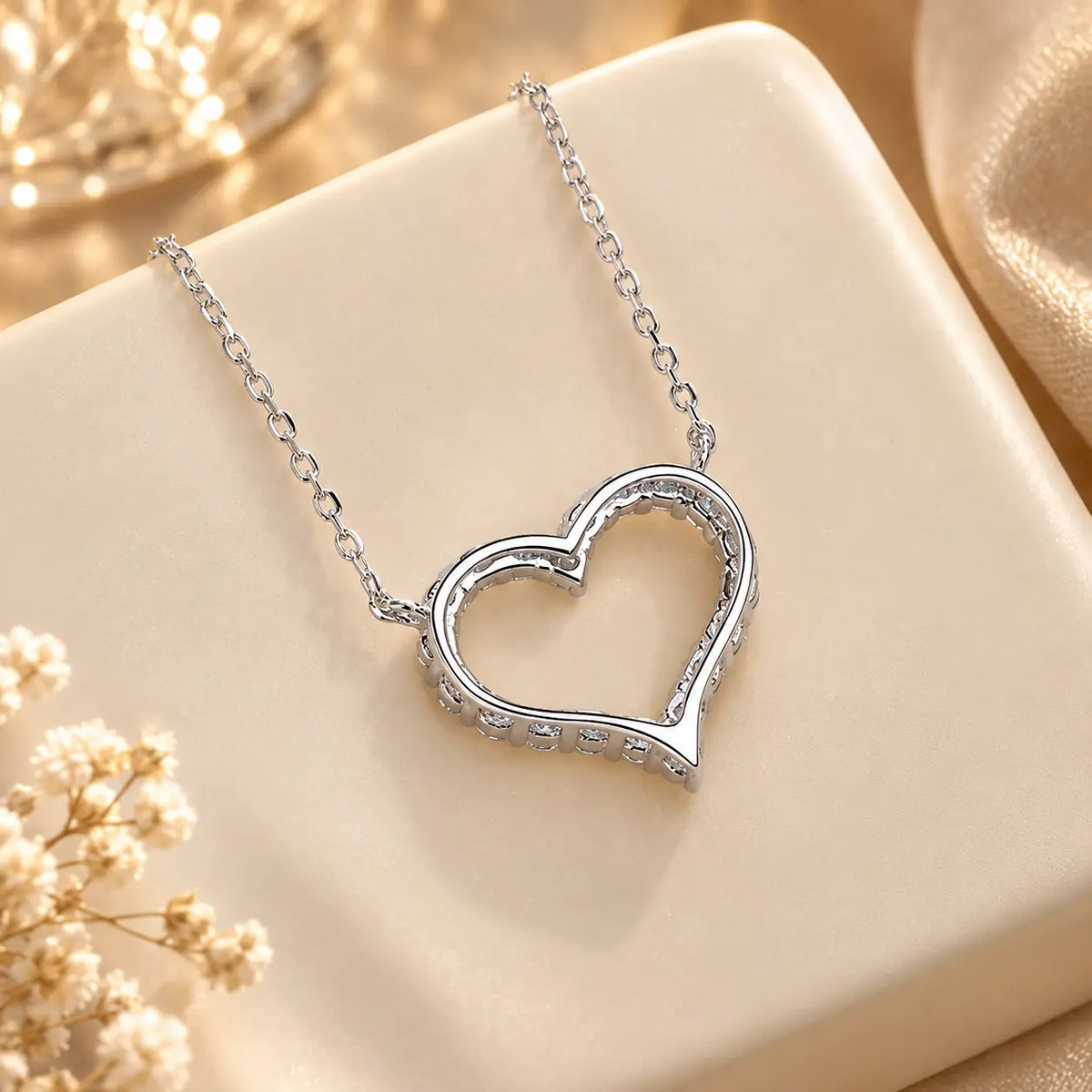 Back detail of an open heart moissanite pendant necklace showing the pendant setting