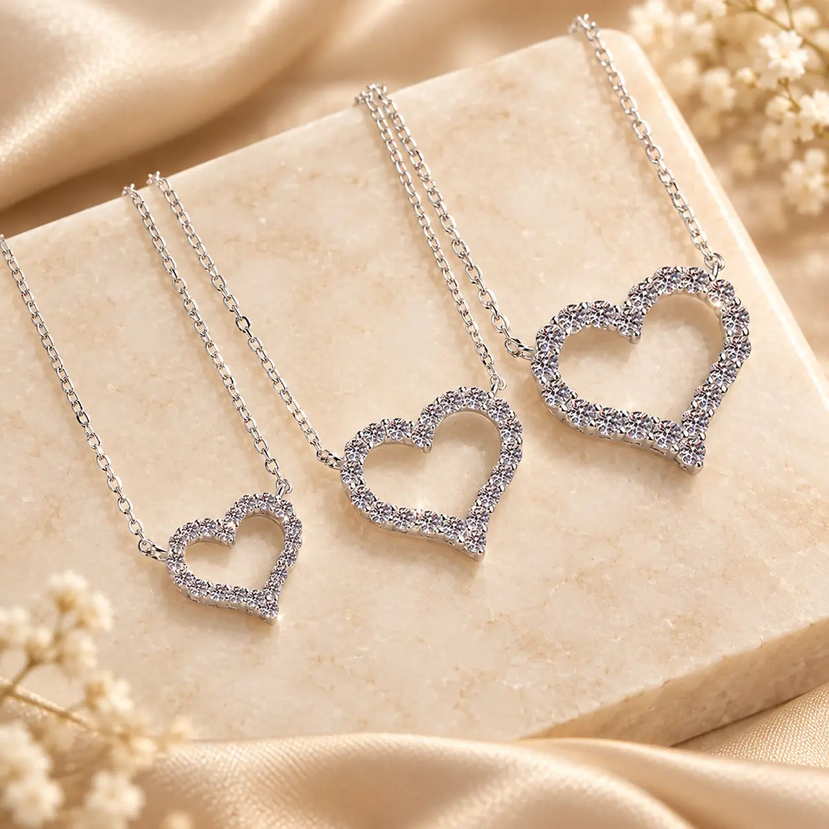 Heart moissanite pendant necklaces shown side by side in multiple stone sizes