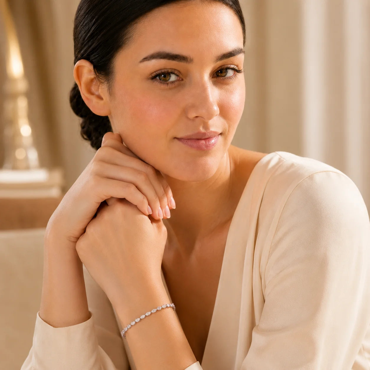 Woman wearing the Langley™ pear-cut moissanite tennis bracelet for women in an elegant luxury setting.