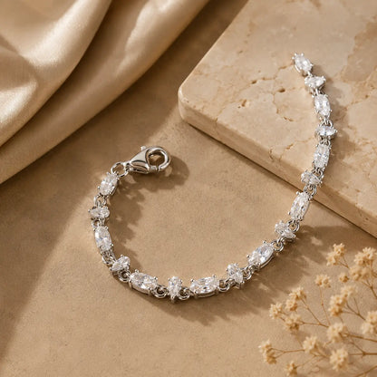 Mixed-cut moissanite tennis bracelet for women displayed open to show the stone arrangement and secure clasp.