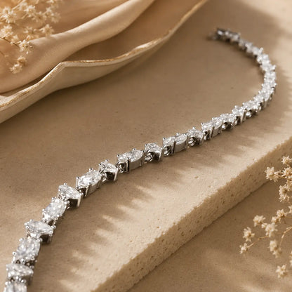Close-up of a mixed-cut moissanite tennis bracelet for women showing brilliant stones and polished silver-tone settings.