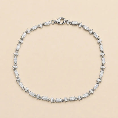 Full view of a mixed-cut moissanite tennis bracelet for women featuring alternating pear and oval-cut stones with a secure lobster clasp.
