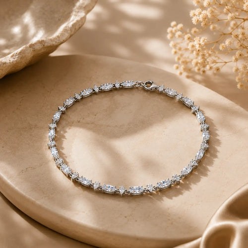 Mixed-cut moissanite tennis bracelet for women displayed in a complete circle on a luxury beige surface.