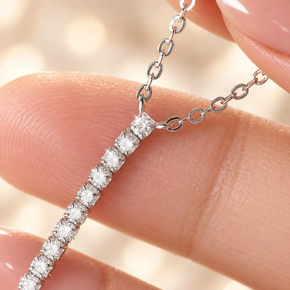 Close-up of the sparkling moissanite stone row on a vertical bar necklace