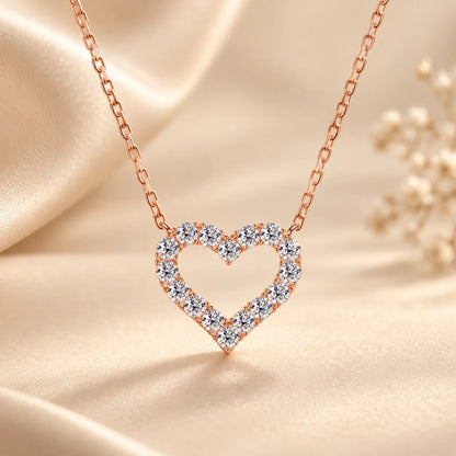 Rose gold tone open heart moissanite pendant necklace styled on soft champagne satin